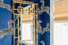 04 bold blue wallpaper with a zebra print and a gilded frame mirror mka eup the whole look of this space
