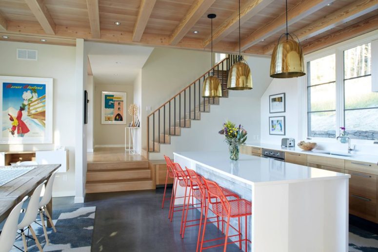 The kitchen features wooden cabinets, a sleek white island and coral colored srools plus magnificent views as everywhere The kitchen features wooden cabinets, a sleek white island and coral colored srools plus magnificent views as everywhere