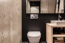 05 a black wall, black hex tiles and a contrasting concrete wall for a modern bathroom with an industrial feel
