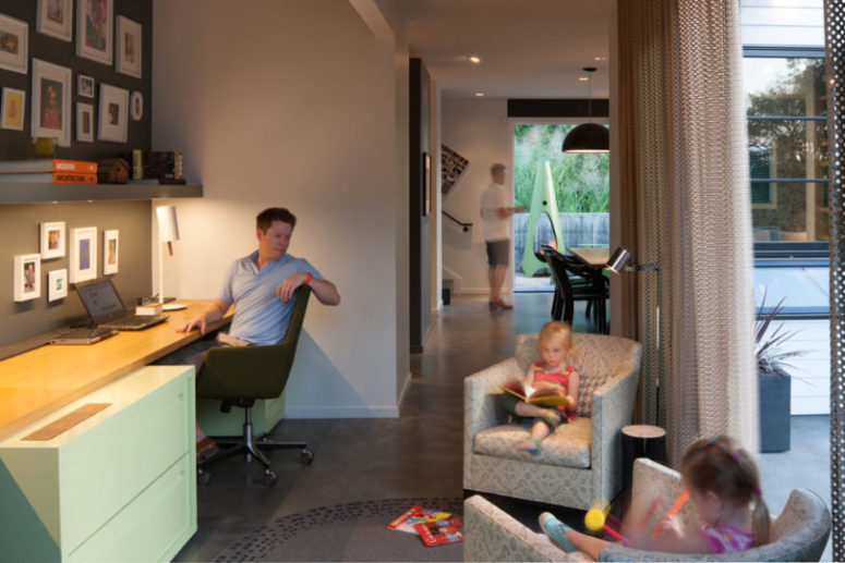 organized working space A small working space with a wall-mounted desk, mobile cabinets and armchairs, it may be made more private with curtains