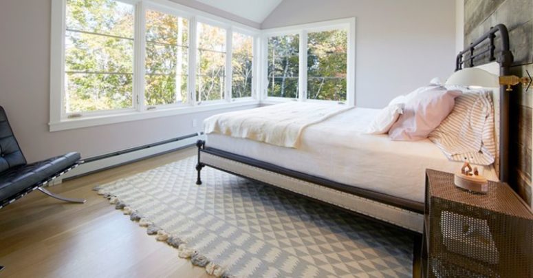The master bedroom is extensively glazed to catch the views, it's clad with reclaimed wood for coziness and the furniture is modern The master bedroom is extensively glazed to catch the views, it's clad with reclaimed wood for coziness and the furniture is modern
