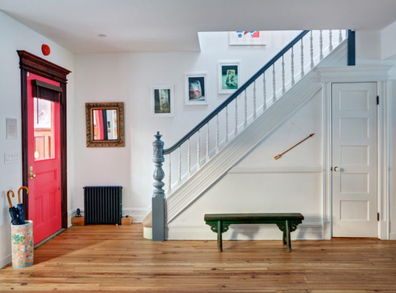 The entryway is also colorful, with a pink door and colorful artworks