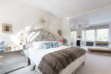 07 The master bedroom features floral print fabric, which is used for upholsterign the bed, curtains, furniture