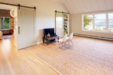 07 There’s a comfortable space for watching TV and just inviting friends, and sliding barn doors make the space cozier yet keep it modern