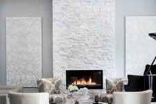 07 a glam neutral space with a white stone clad fireplace for a chic refined look