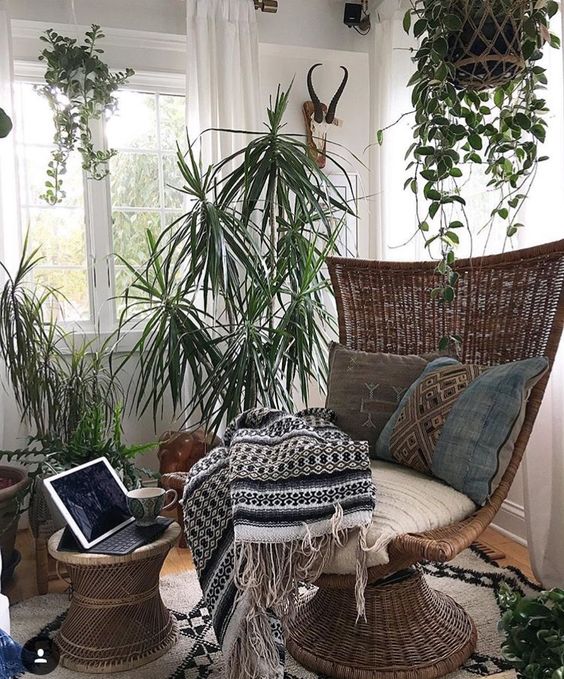 a modern wicker chair and a side table with an eye-catchy shape look chic and boho