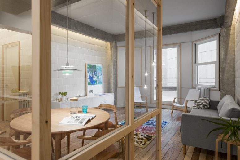 The storage in the living room is done with white cabinets attached to the wall