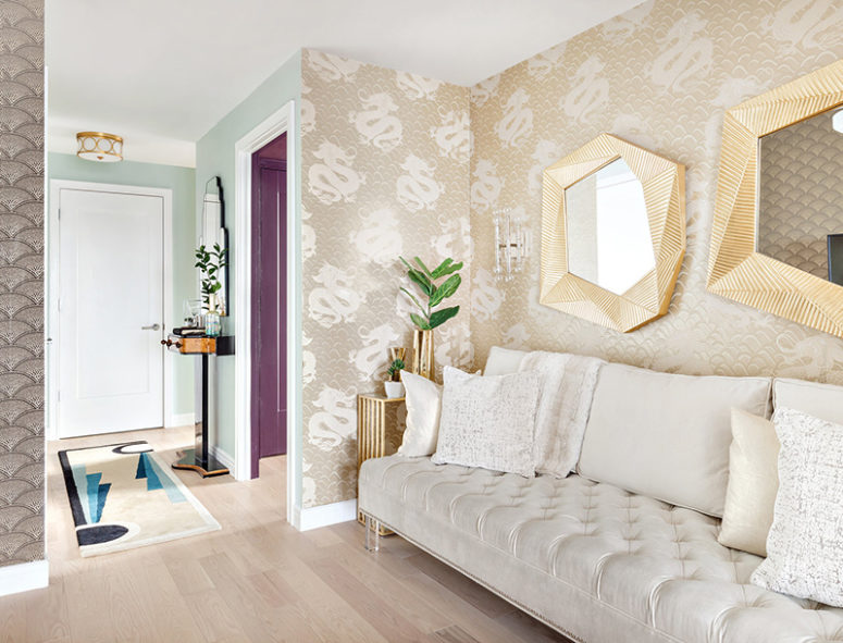 There are two types of wallpaper, a creamy velvet sofa and again brass touches to accentuate the space