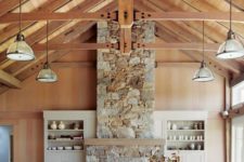 08 a gorgeous vacation home with a stone clad fireplace and a wooden mantel for a cozy feel