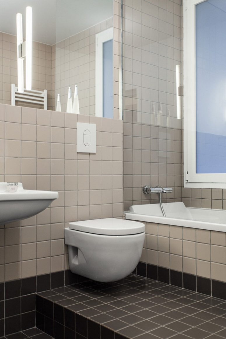 The bathroom was done with tiles of two matching yet contrasting shades - beige and dark chocolate