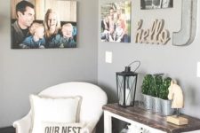 09 a small nook with a comfy chair, a console table and family photos and signs all over