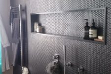 09 black penny tiles on the shower wall give it a textural look and add eye-catchiness to the bathroom