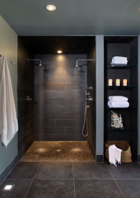 large scale black tiles on the walls and floor and some grey touches for a modern dark bathroom
