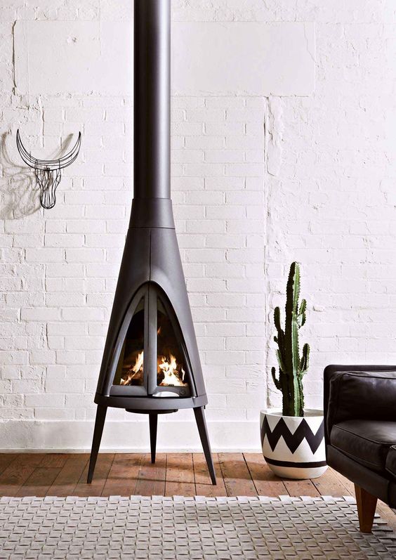 an eclectic boho-inspired space with a modern free-standing stove looks more inviting