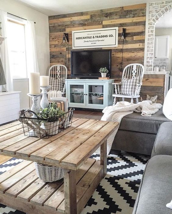 a farmhouse space with a reclaimed wooden wall, a coffee table and vintag chairs
