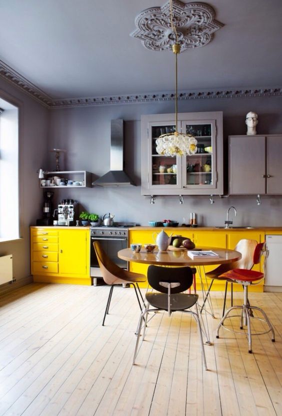a gorgeous grey lavender moody kitchen with bold yellow cabinets to contrast and enliven the space