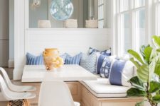13 a wooden corner bench with storage space and lots of pillows for a cozy breakfast nook