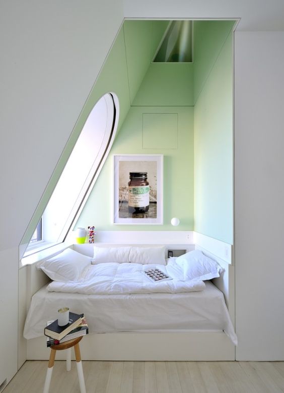 an awkward attic corner is taken by a whole comfy bed where you can have a daytime nap or jsut read