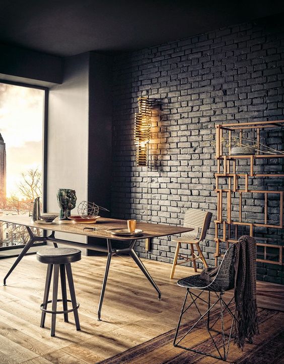 an industrial home office with a black brick wall that brings a cool textural look