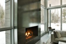 13 an ultra-modern fireplace clad with dark metal sheets looks very eye-catching and even show-stopping