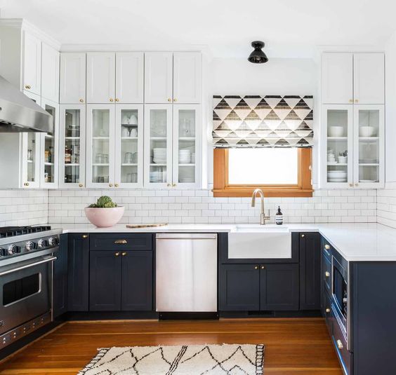 a dark grey and white kitchen looks lightweight though it features a lot of storage space