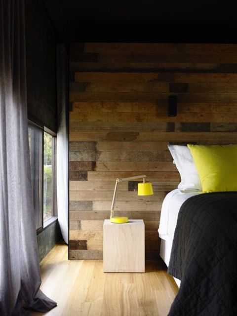 a modern space with a reclaimed wooden wall and modern furniture and neon touches