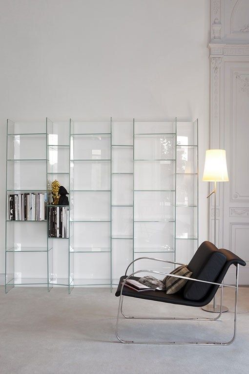 a clear glass wall unit looks ethereal and disappearing in the air while giving enough storage space