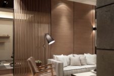 15 a modern living room with a wooden wall, the part of which is of planks that create a space divider