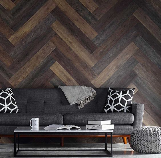 a modern space is made more eye catching with weathered wood of various shades clad in a diagonal pattern
