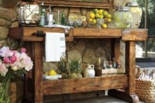 16 a rustic vintage kitchen island turned into an outdoor bar with a vintage feel