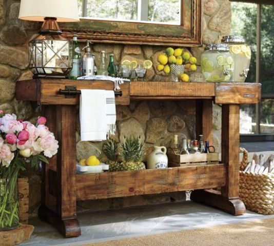 a rustic vintage kitchen island turned into an outdoor bar with a vintage feel
