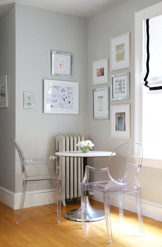 a small breakfast space with a round table and acrylic chairs looks airy and very comfy