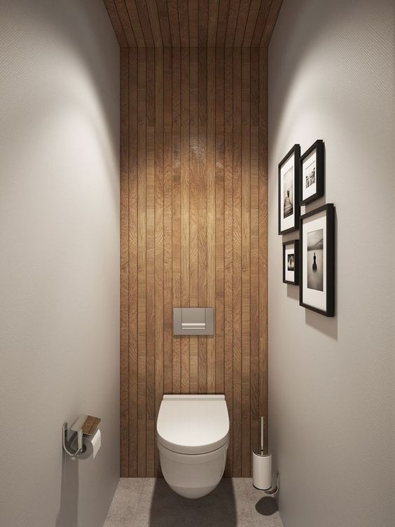 a wood slat wall that comes up the wall to the ceiling and makes the space chic