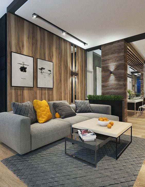 a modern space with a light-colored woodwall behind the sofa and a wood plank pillar