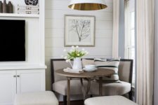 17 a quiet corner with a small breakfast area, a curved sofa and upholstered poufs, a lamp to highlight the space