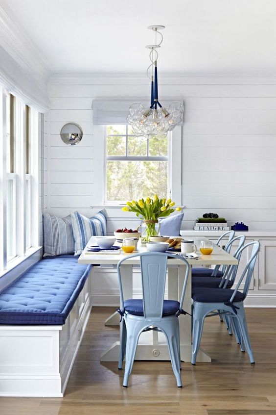 a vintage corner bench with lots of storage and a comfy blue cushion on top