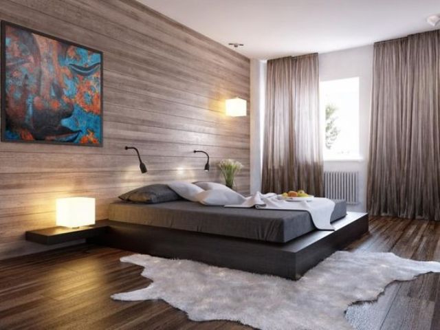 an ultra-modern bedroom with a wood clad wall and matching floor, a plaform bed and a faux fur rug