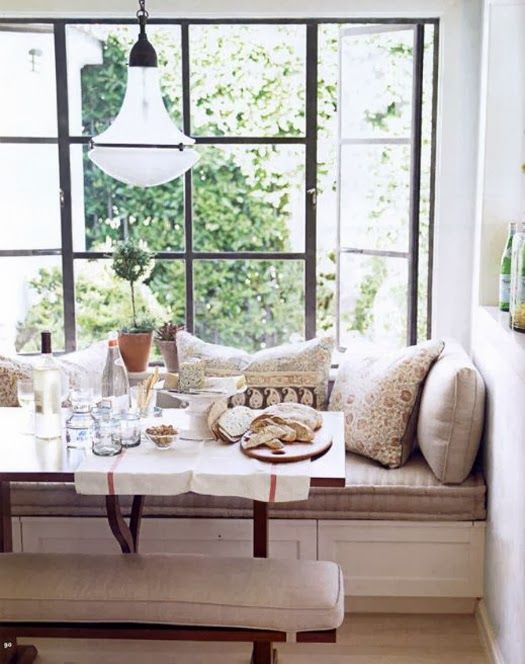 a chic breakfast corner with a windowsill turned into a comfy upholstered bench