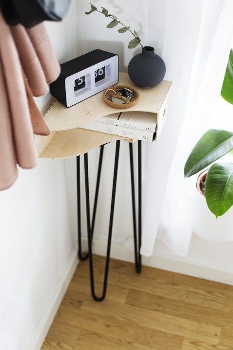 a small side table on hairpin legs used in a small corner to make the use of it