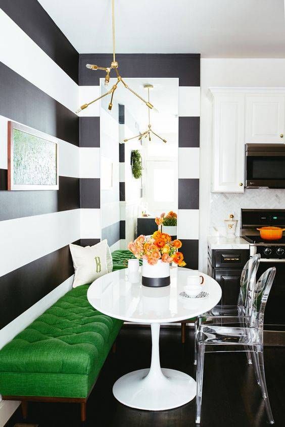 a bold green upholstered surface to add color to a monochromatic space