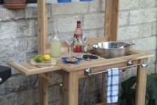 19 a custom-made wooden bar stand for a rustic patio provides comfort in using