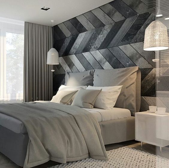 a modern space with a chevron clad wooden wall in grey and black