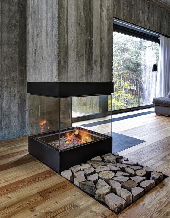 an ultra-modern fireplace with reclaimed wood and a glass part to be visible from all sides