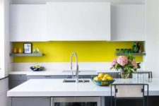 21 a minimalist kitchen in grey and white and with a neon yellow backsplash for a colorful touch