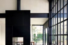 22 a large double-sided fireplace clad with black tiles steals the show and catches every eye