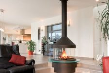 22 a modern glass fireplace is a stunning feature for the whole open space