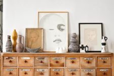 22 a vintage apothecary cabinet of light-colored wood to make a statement in a living room