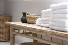 22 a wooden bench and some baskets for storage will add a spa feel to your bathroom