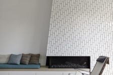 23 white tiles that imitate bricks and are clad using an eye-catchy pattern are amazing
