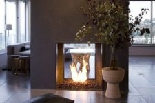 24 a bold concrete fireplace with a glass part is a great fit for a modern cabin and it brings more texture to the decor